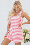 Woman wearing a pink and white striped dress with a white background