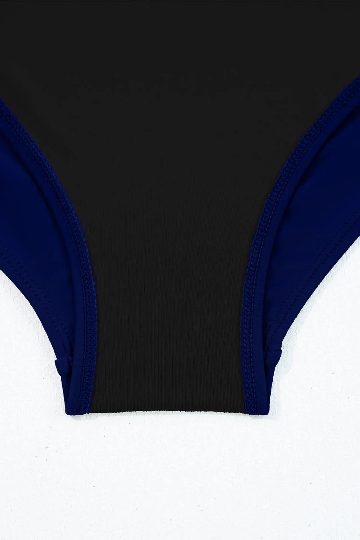 Close-up of a black and blue bikini top on a white background