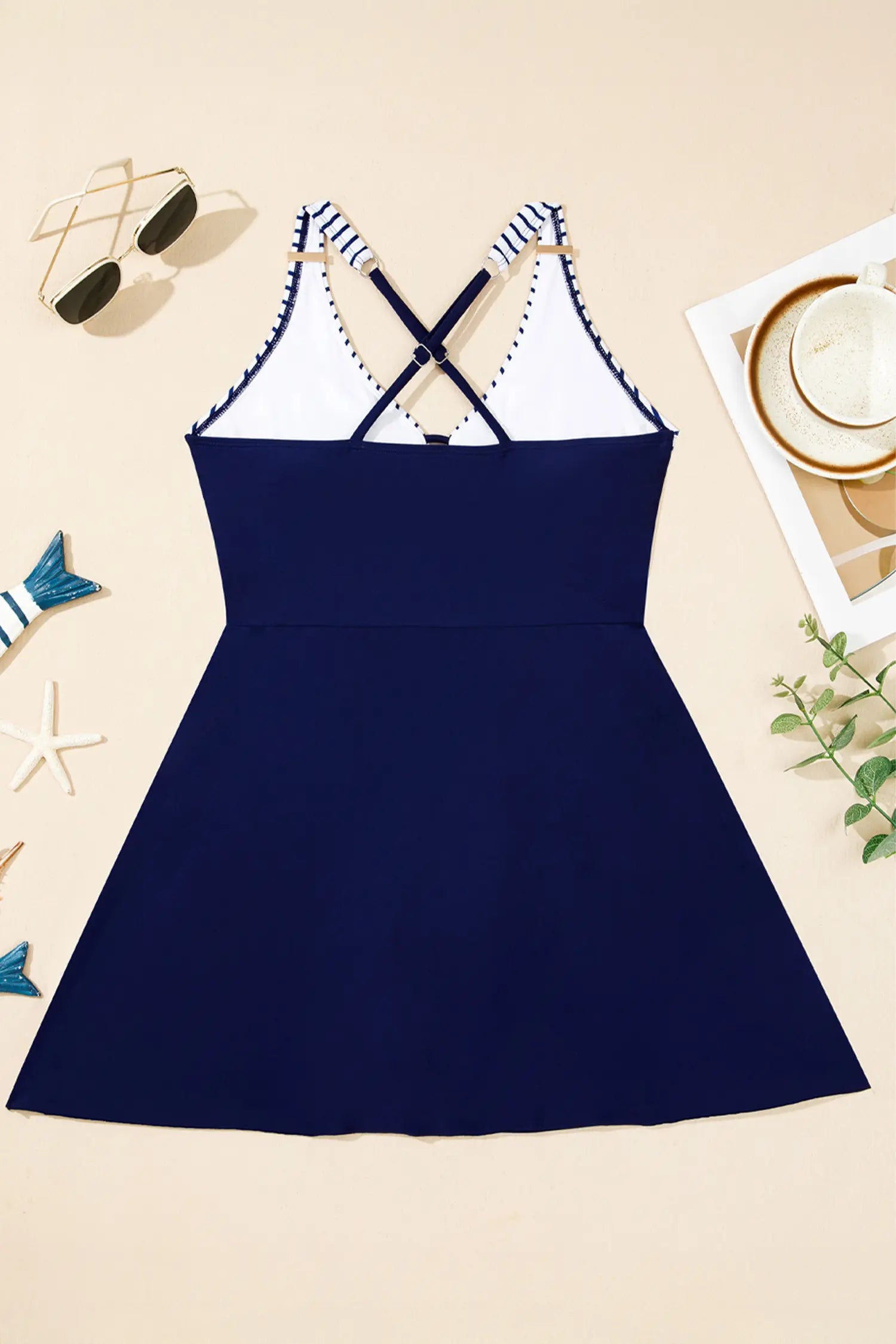 Navy blue dress with white lace details on a beige background