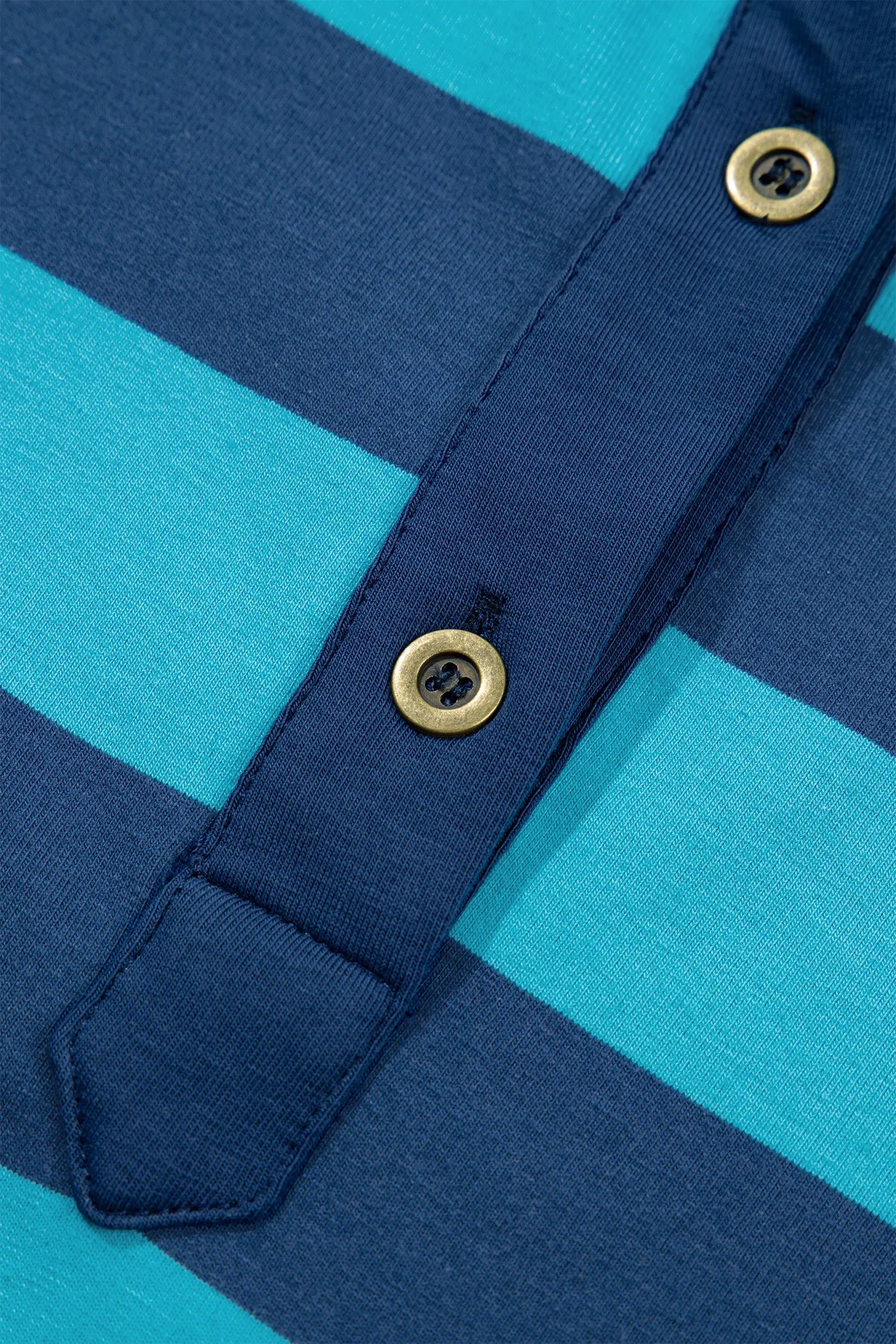 Close-up of navy-turquoise striped knit garment with gold-tone button placket.