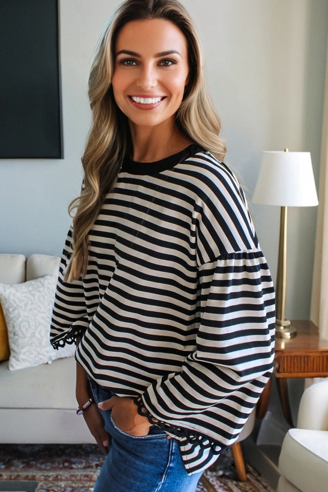 Woman wearing a black and white striped sweater in a living room setting
