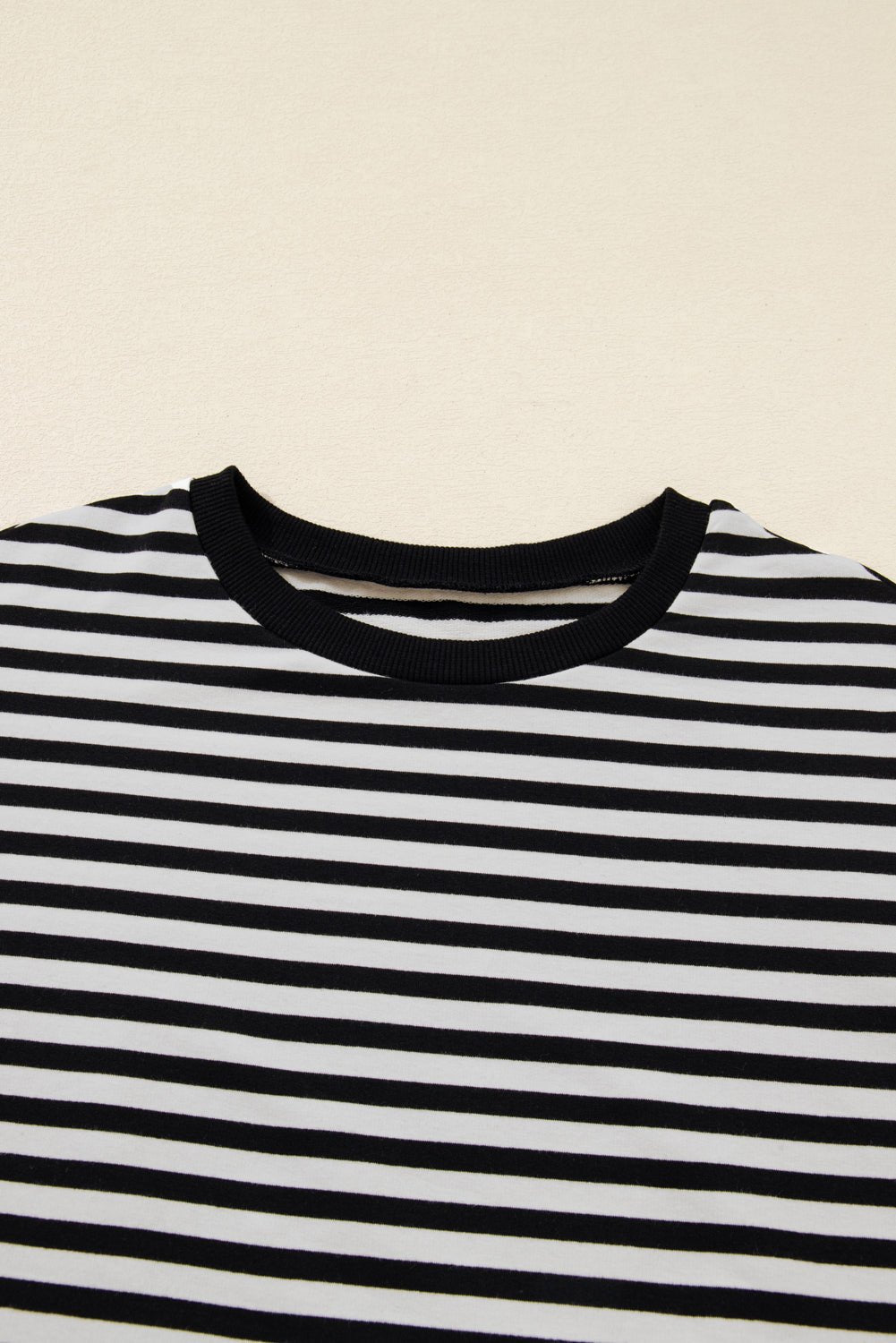 Black and white striped shirt on a beige background