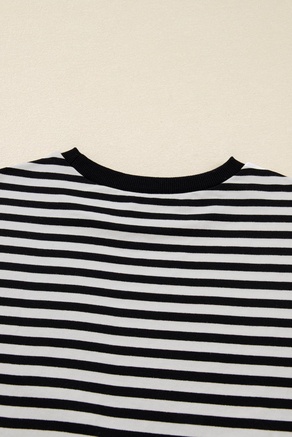 Black and white striped shirt on a beige background
