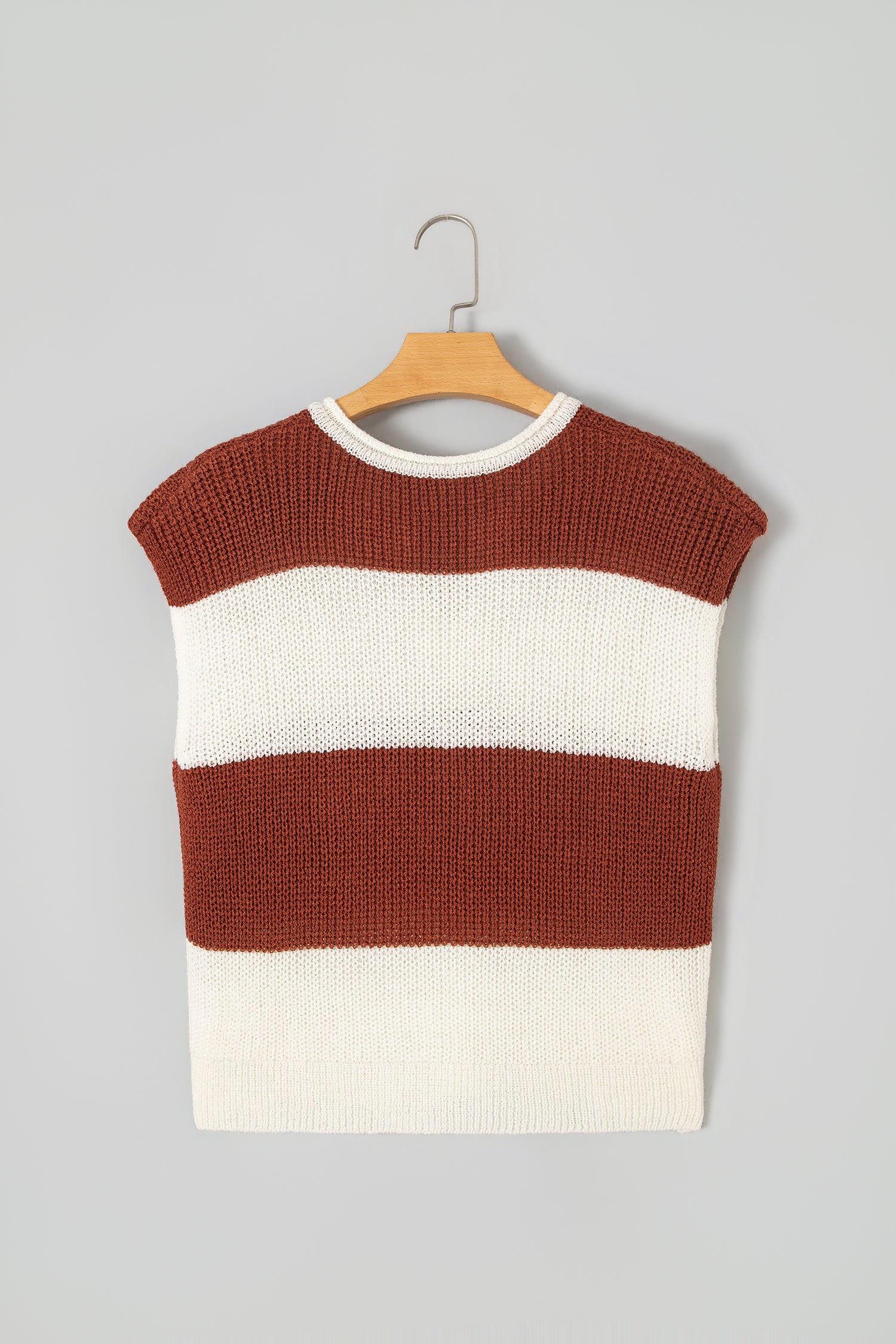 A sleeveless knit sweater vest with horizontal stripes in rust brown and off-white, hanging on a wooden hanger against a solid light gray background.