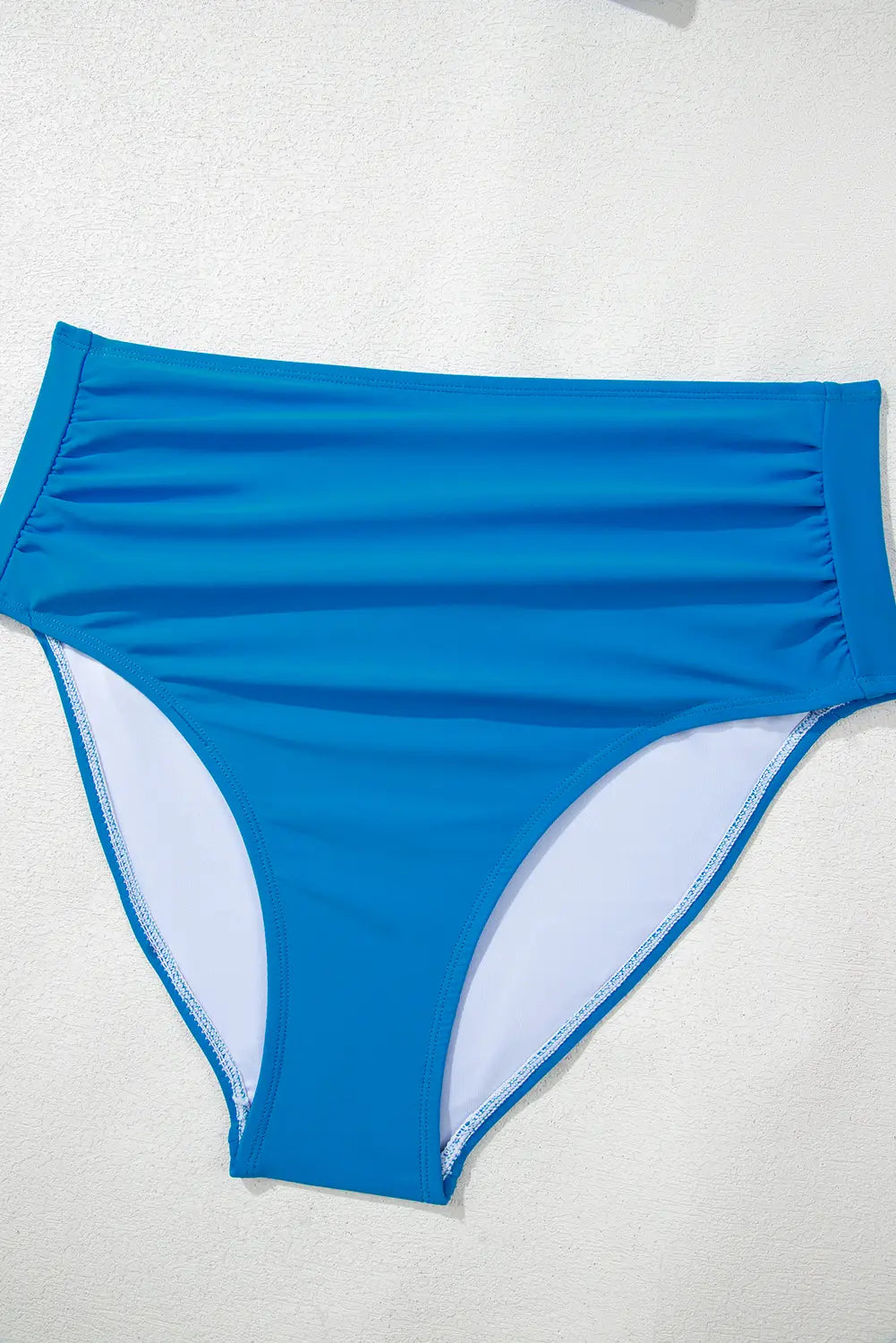 Blue swim bottoms on a white background