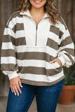 A woman wearing a brown and off-white horizontally striped quarter-zip pullover sweatshirt with a mock neck and front pockets, paired with blue jeans.