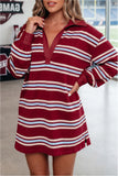 A woman wearing a long-sleeve collared rugby-style mini dress with horizontal stripes in burgundy, cream, and light blue, standing indoors.