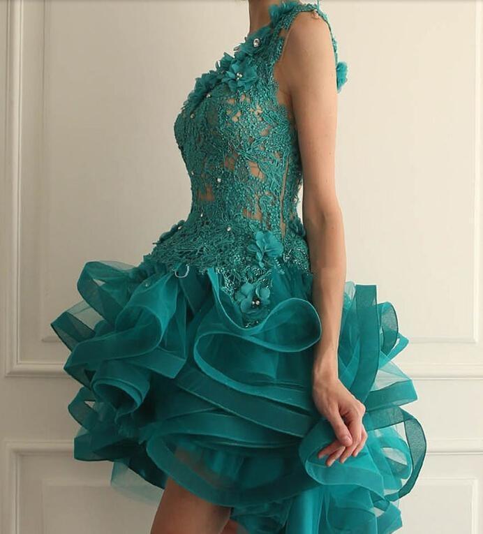 Teal lace dress with ruffled skirt on a neutral background