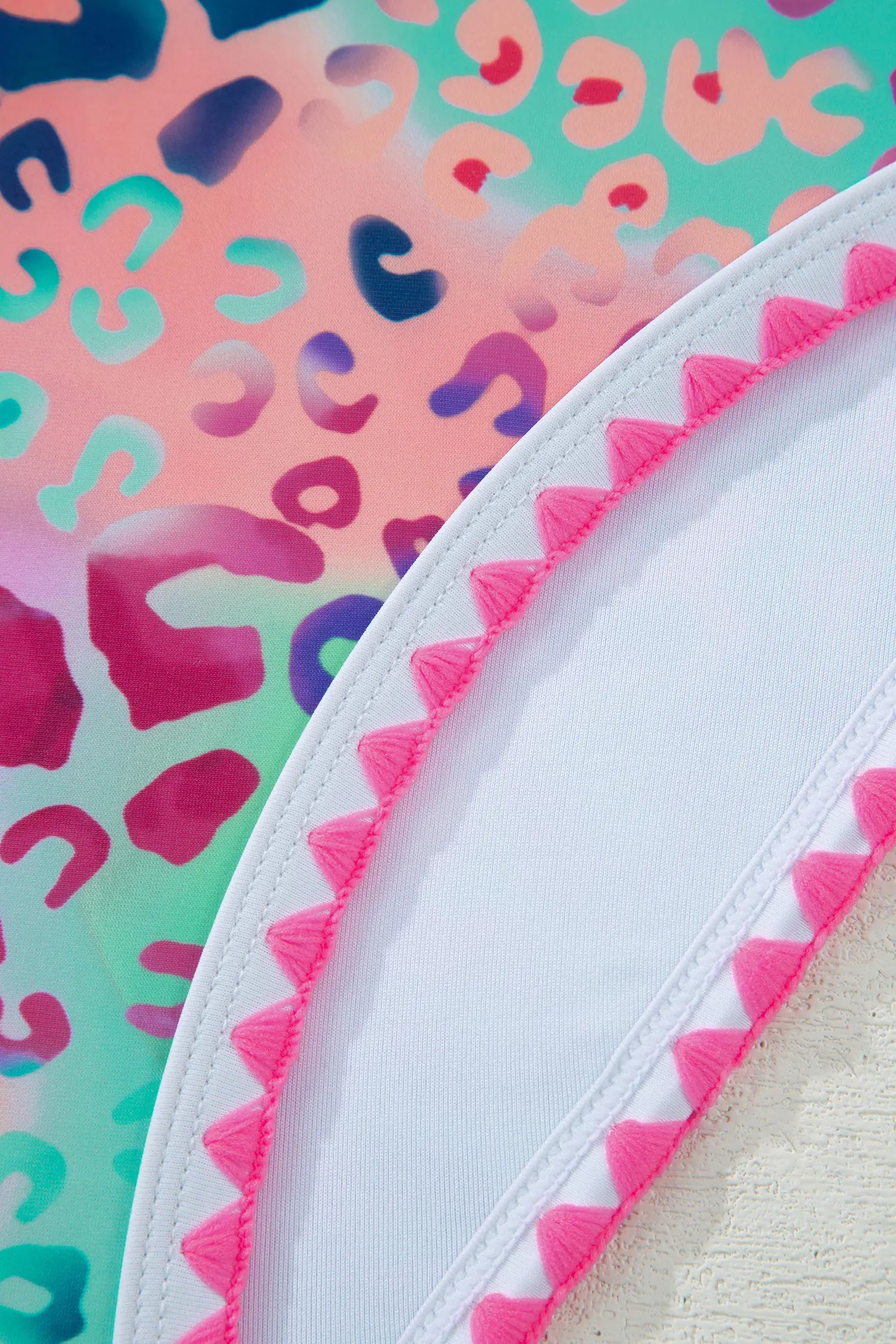 Close-up of a product with colorful patterned background and pink trim