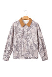 Long-sleeve utility jacket with gray and beige abstract camouflage print and contrasting tan collar on hanger.