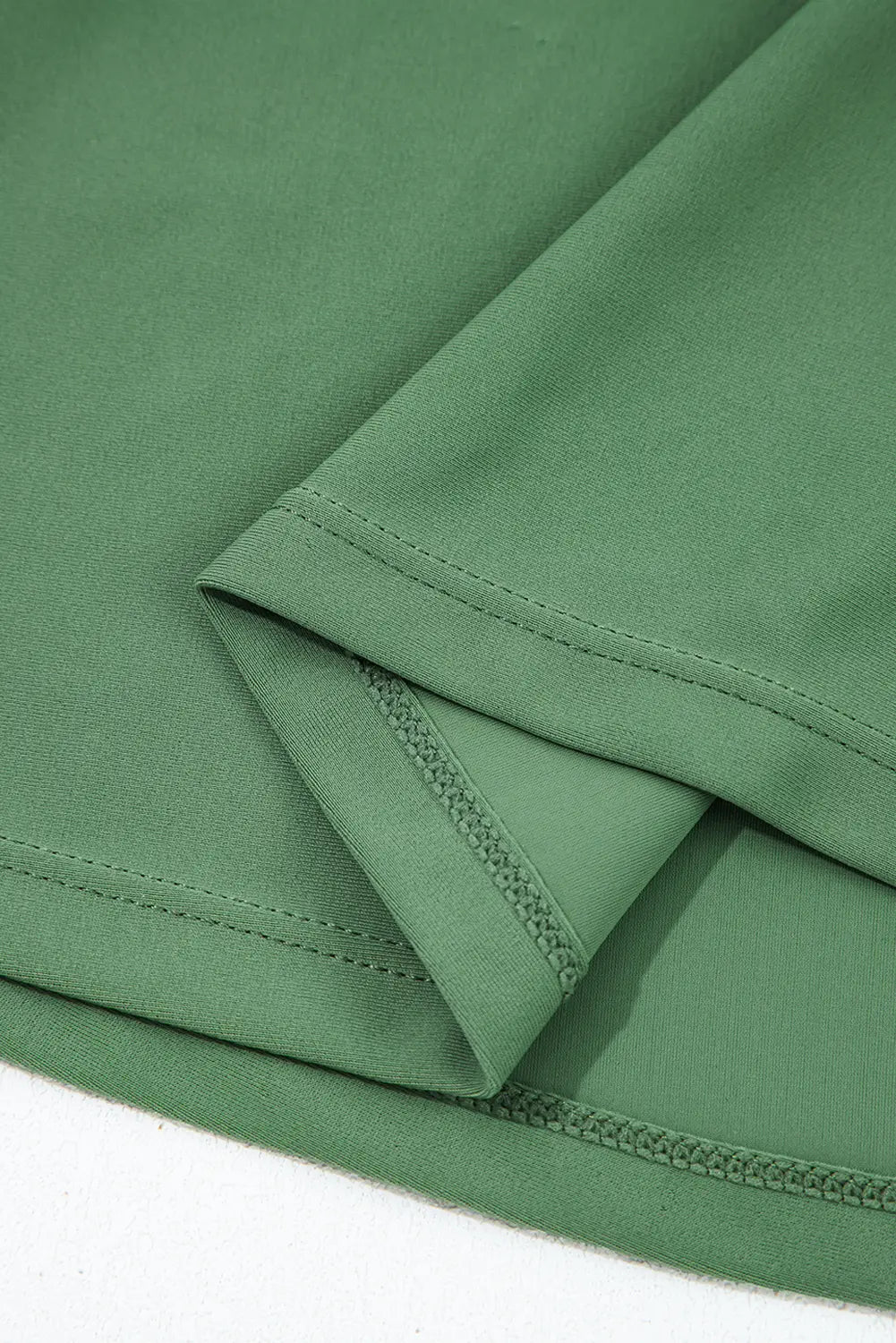 Close-up of green fabric with a white background