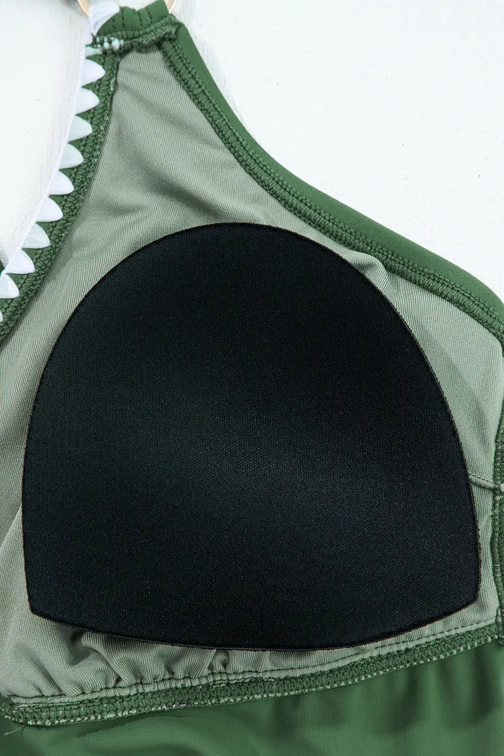 Green bikini top with shark fin design on a white background