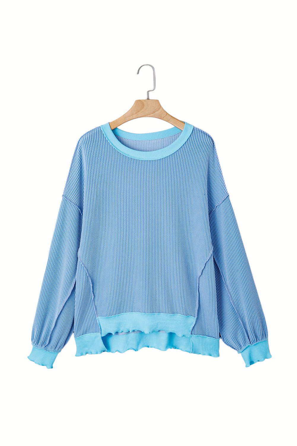 Blue sweater on a hanger against a white background
