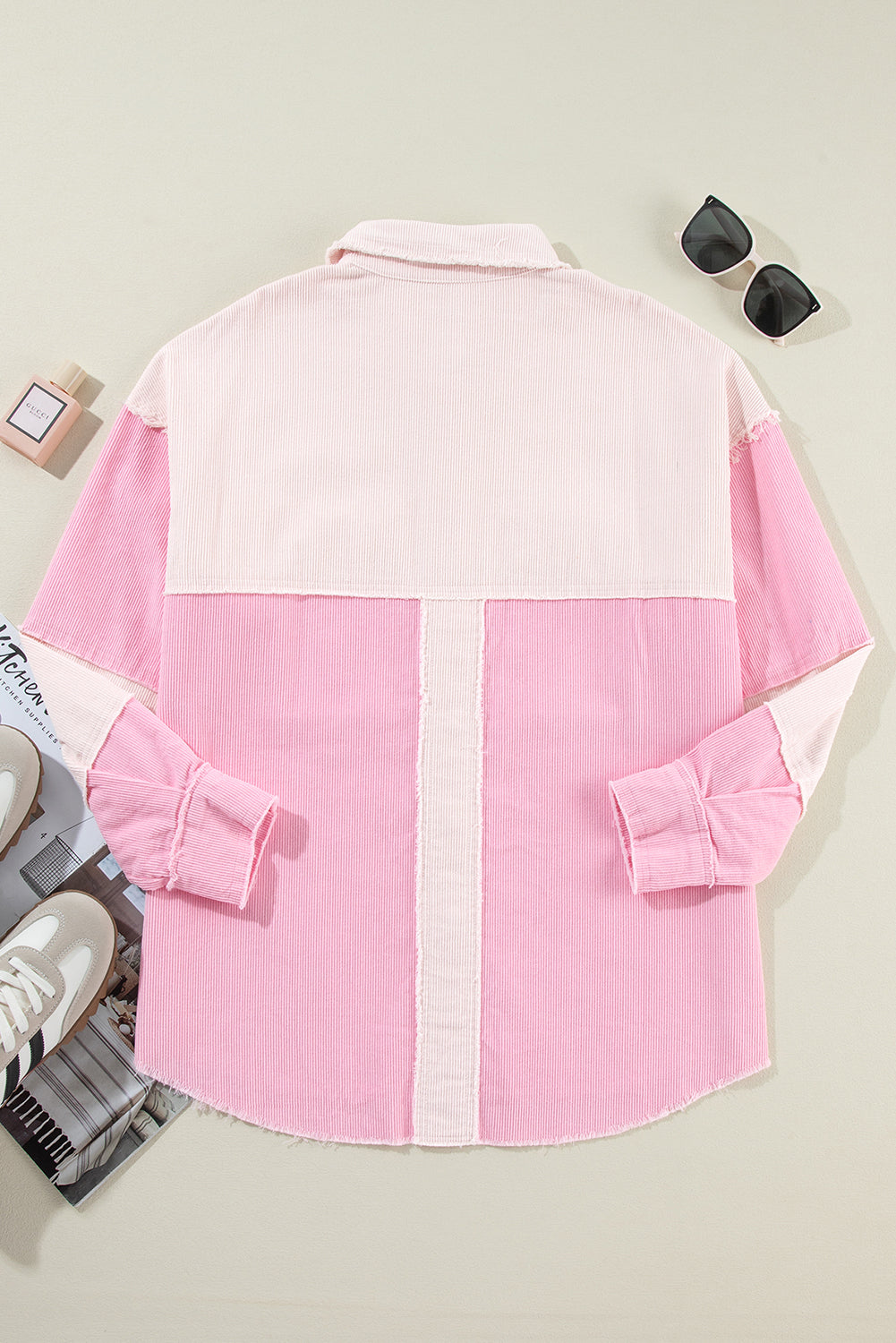Pink denim shirt with white accents on a light gray background