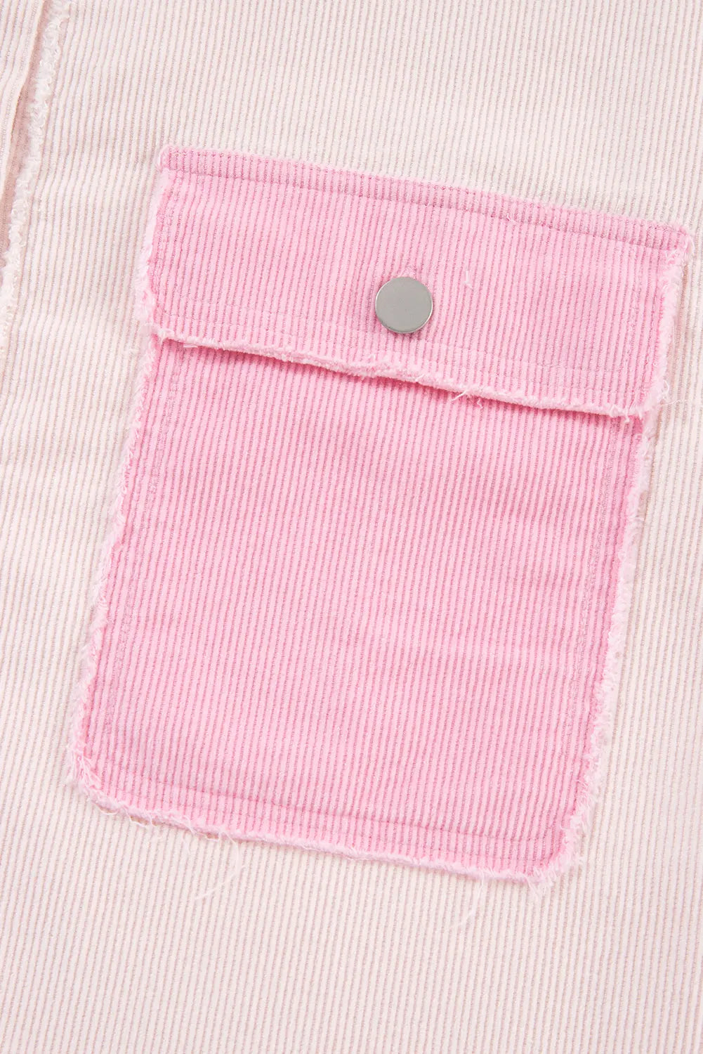 Pink fabric pocket with a button on a light pink background