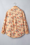 Peach-beige floral button-up shirt with orange, red and green print hanging on a wooden hanger.