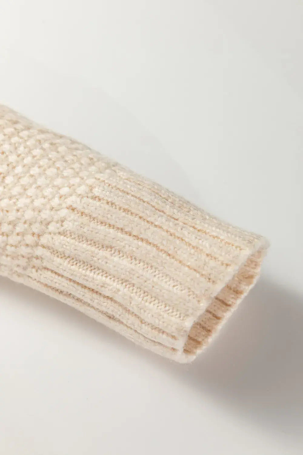 Close-up of a textured beige cylindrical object on a light gray background
