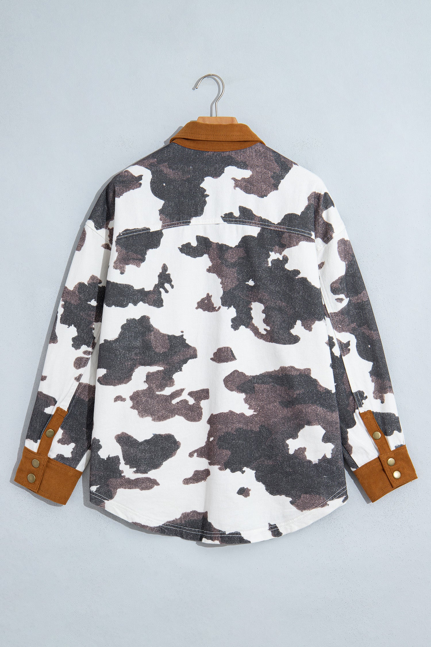 Long-sleeve camo shirt with brown, black, white pattern and faux-leather trim on collar and cuffs.