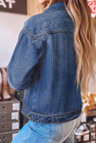 A woman wearing a cropped blue denim jacket, shown from the back 