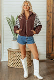 Woman in brown sherpa vest with leopard sleeves, denim shorts, and cowboy boots.