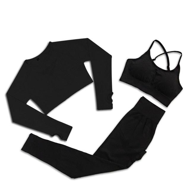 Black long-sleeve top, black leggings, and black sports bra on a white background