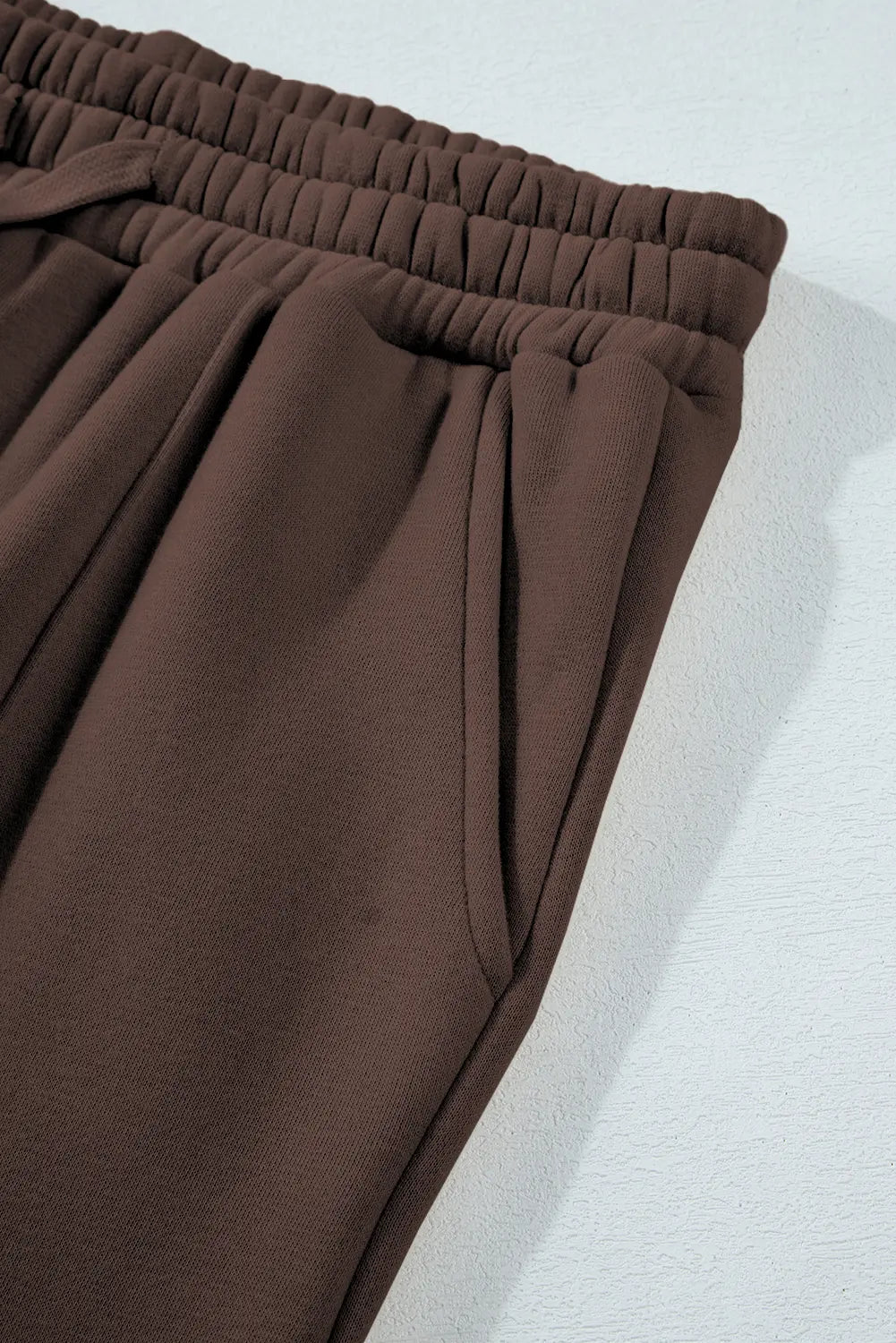 Brown pants on a light gray background
