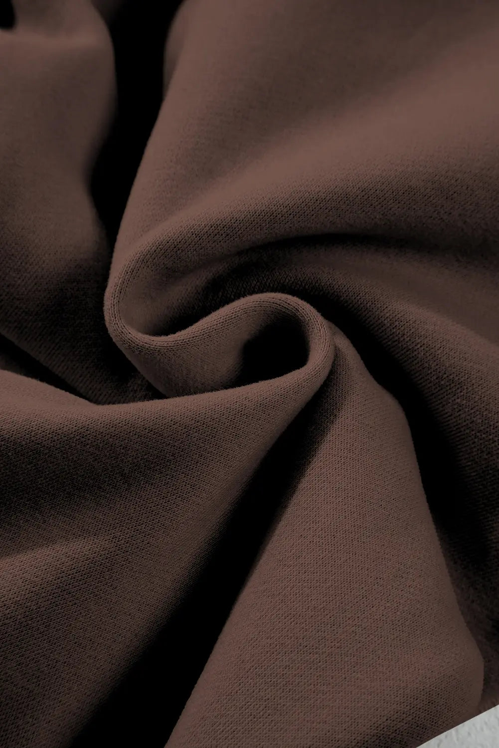 Close-up of brown fabric with folds