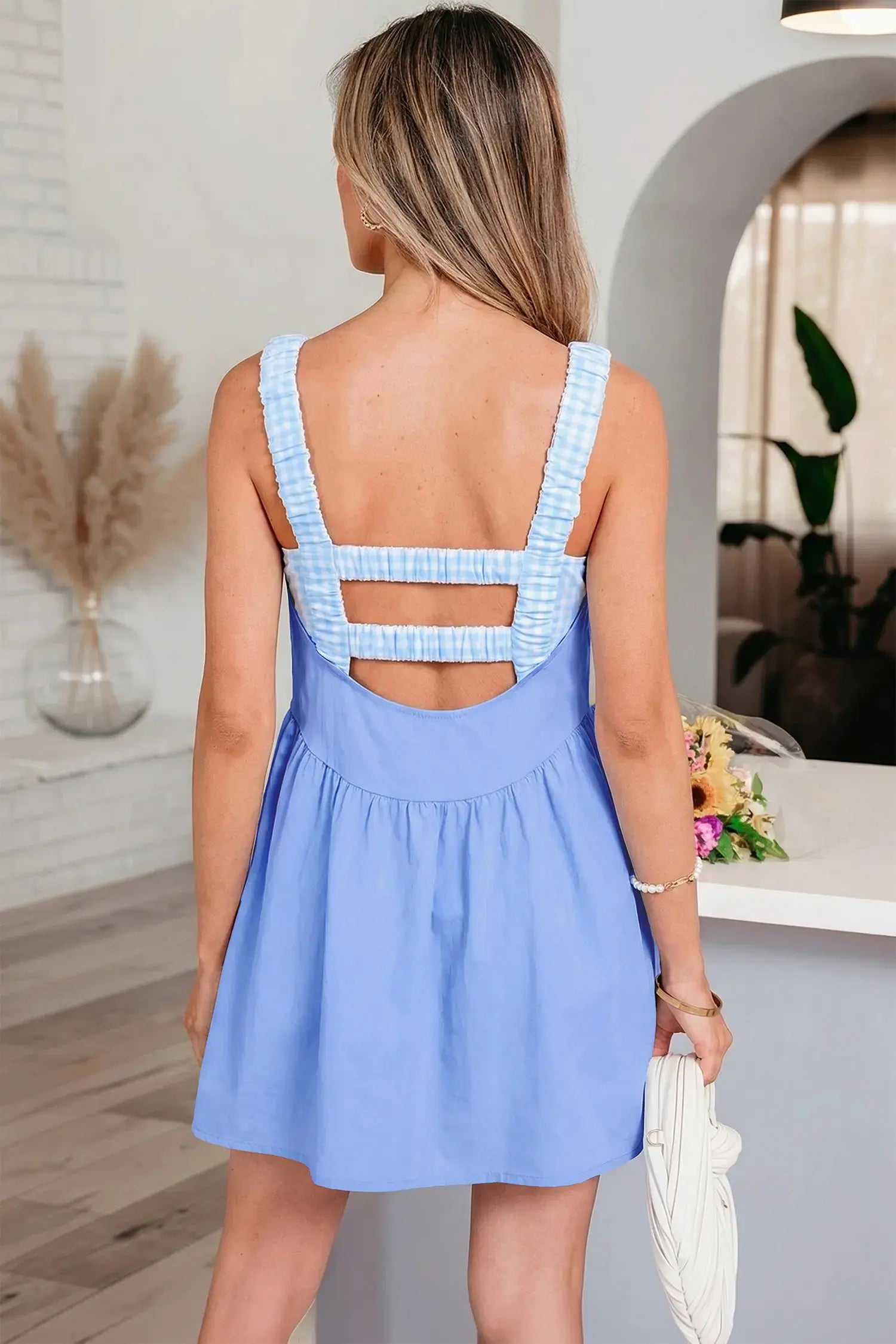 Woman wearing a light blue dress with a white background