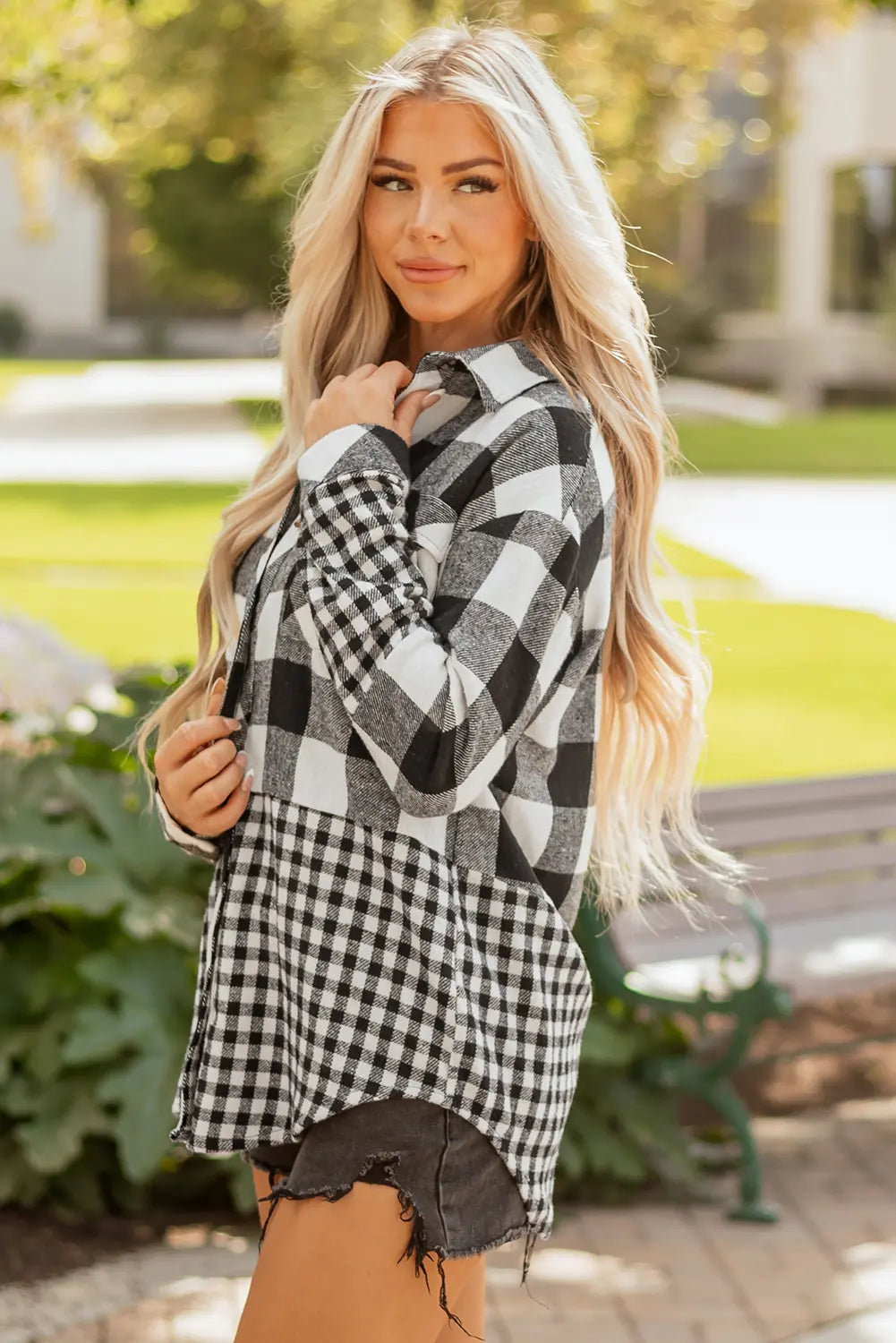 Woman wearing a black and white checkered shirt outdoors
