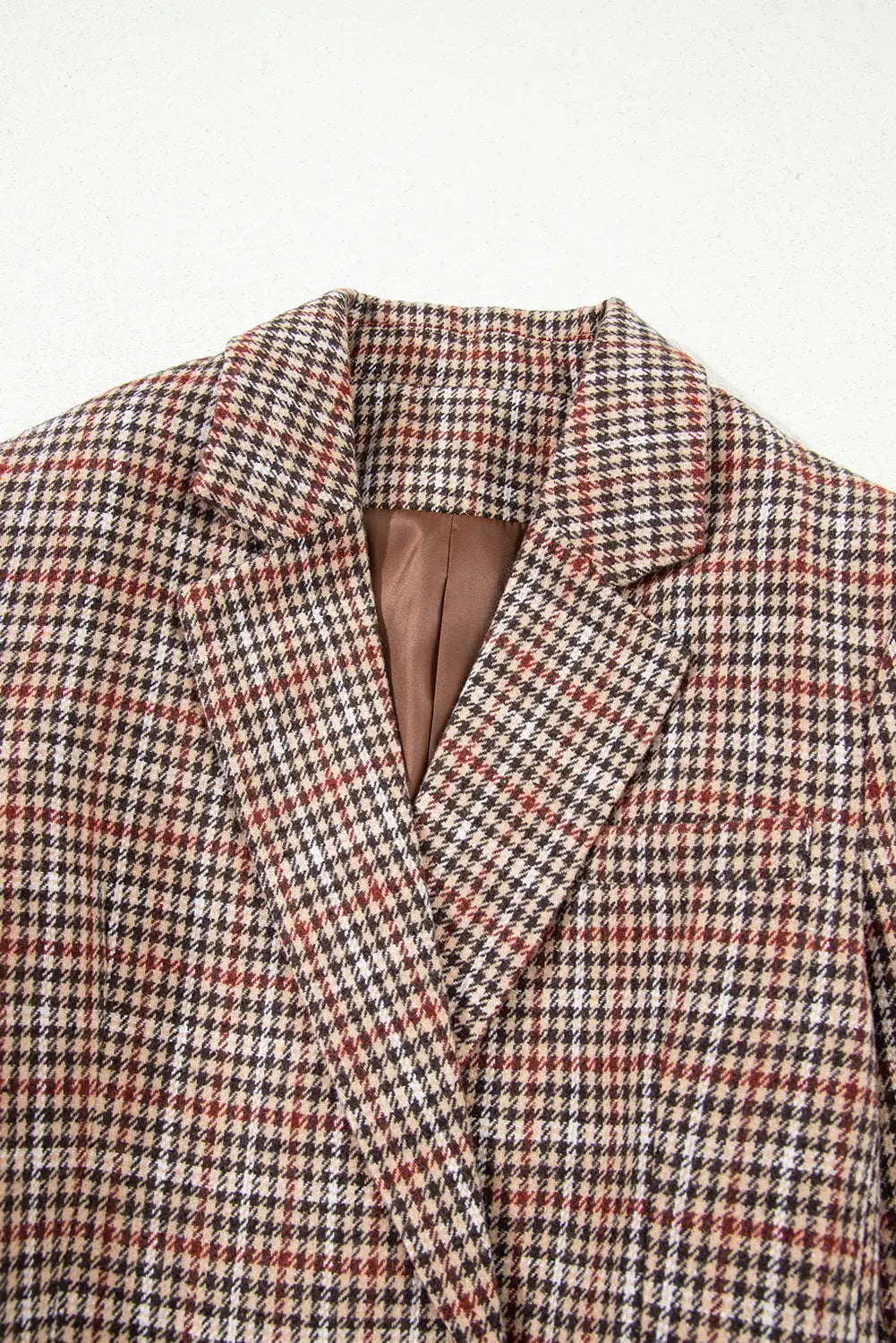 Houndstooth patterned blazer on a light gray background
