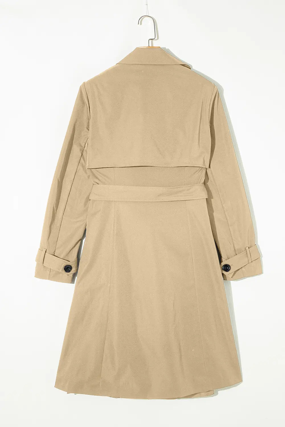 Beige trench coat on a hanger against a white background