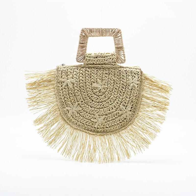 Woven handbag with fringe details on a white background