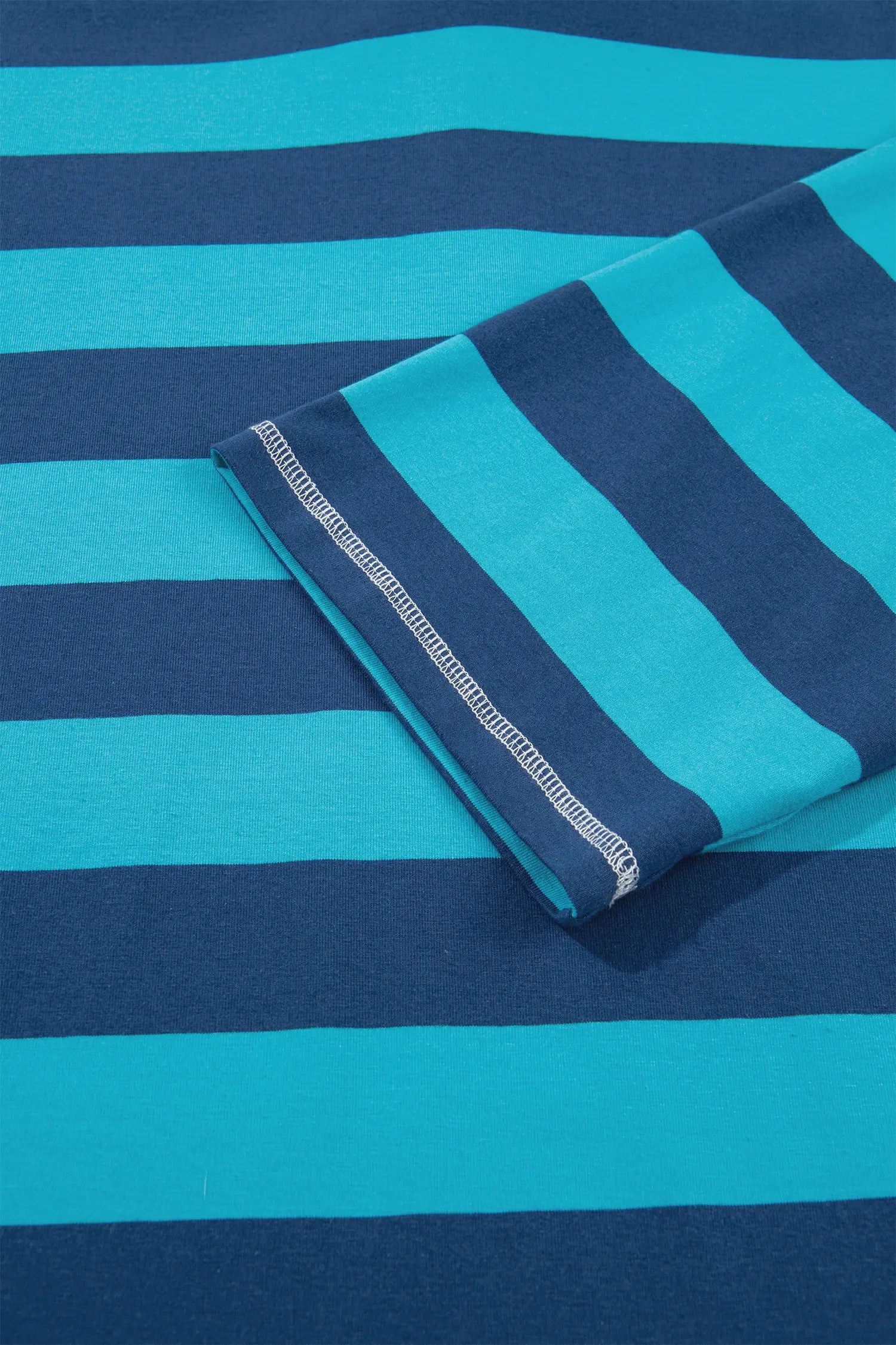 Folded navy and turquoise striped fabric with white zigzag stitched edge.