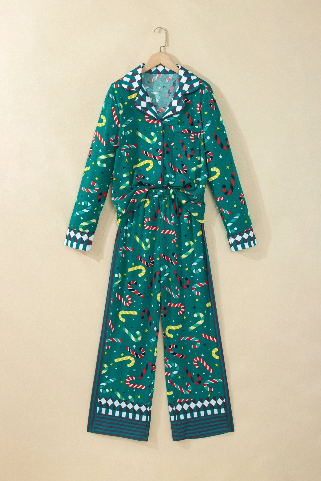 Teal green candy cane pajamas with collared top and wide-leg pants on hanger.