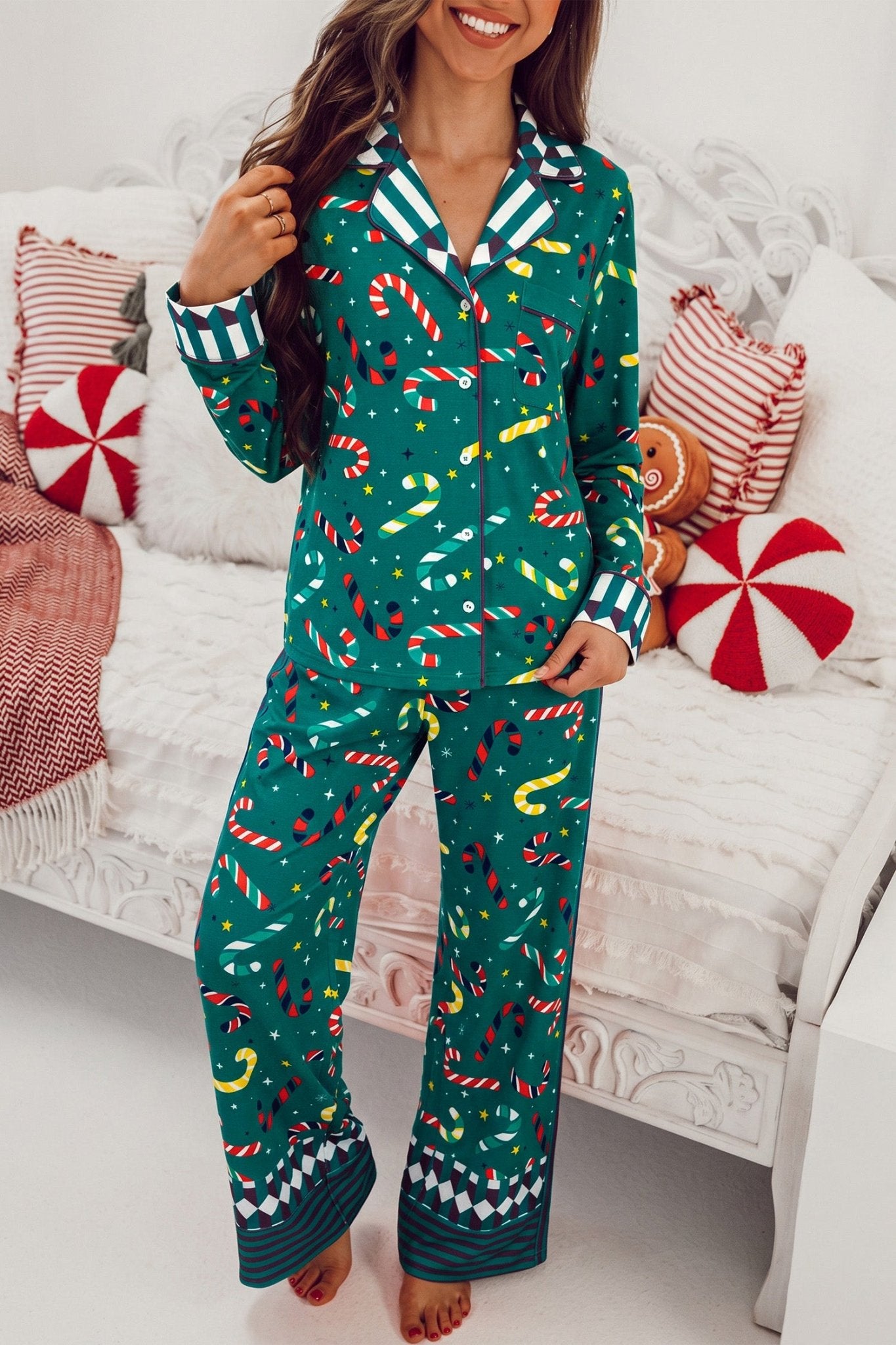 Woman in green holiday pajamas with candy cane, snowman, and Christmas tree print.