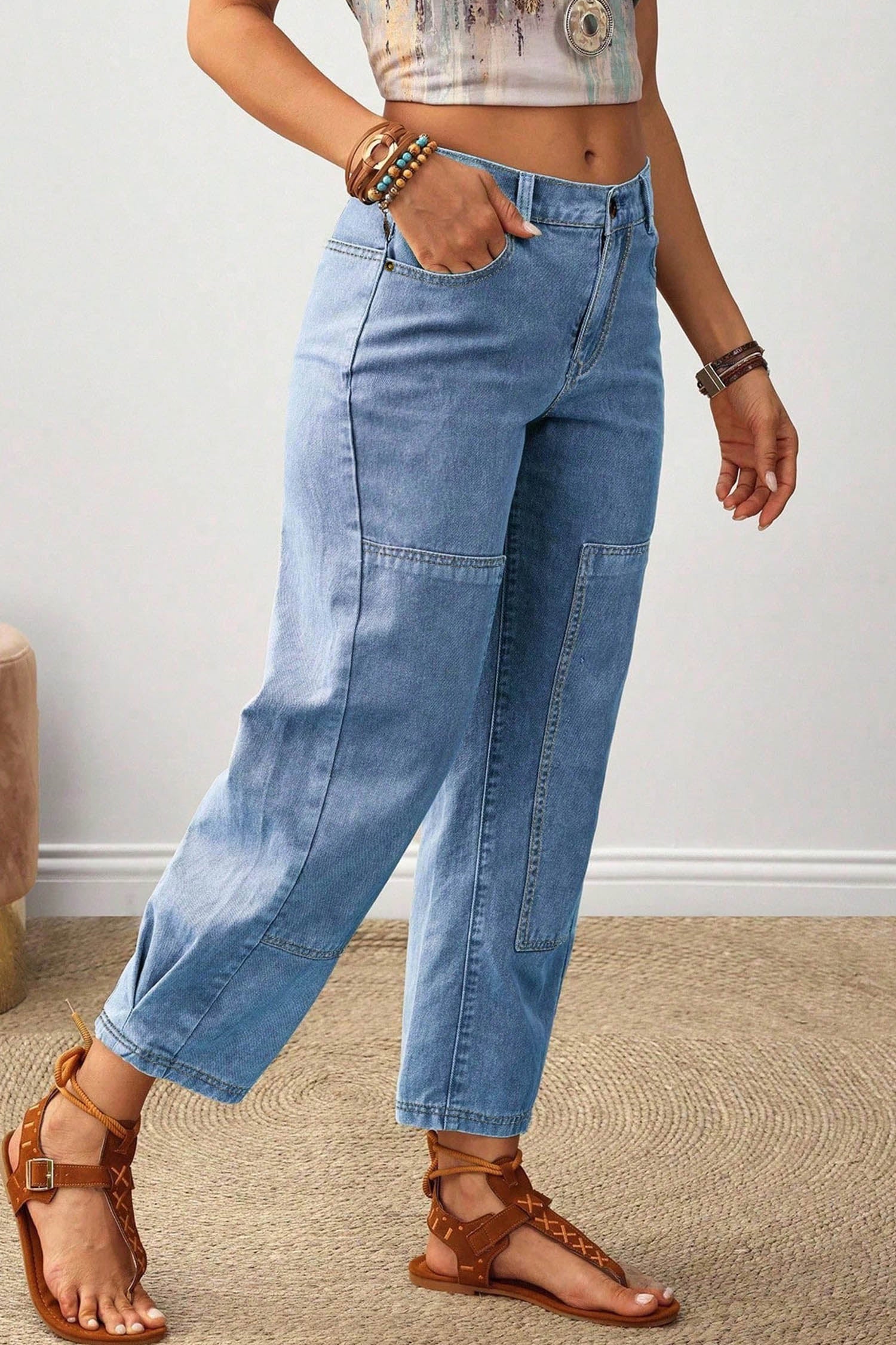Side view of light blue cropped barrel leg jeans with patchwork seams