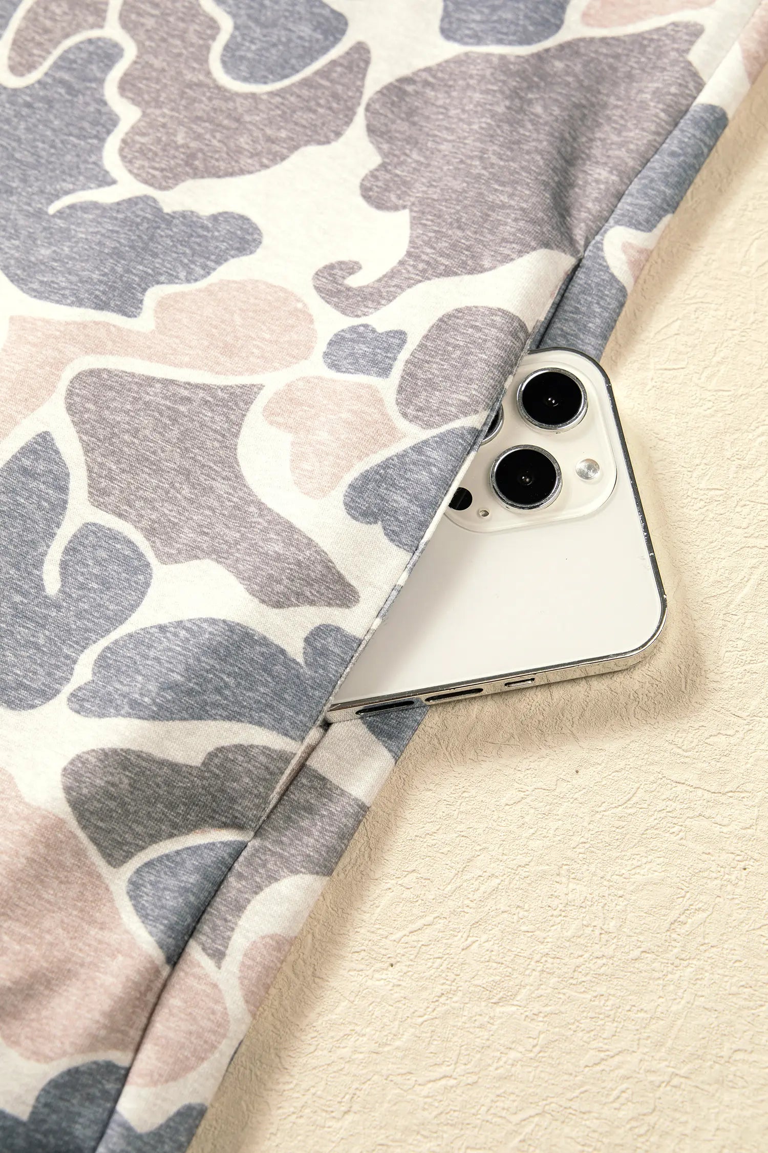 Hem detail on the beige camo print sweatshirt dress