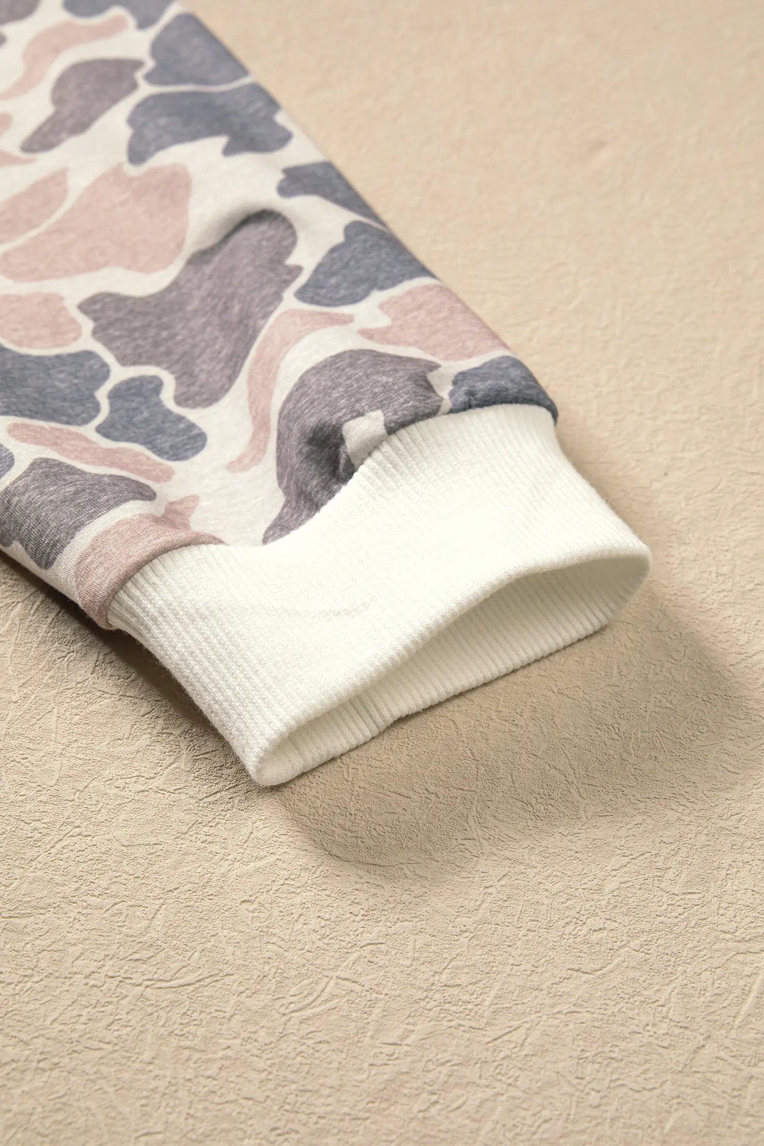 White ribbed cuff on the camo print long sleeve