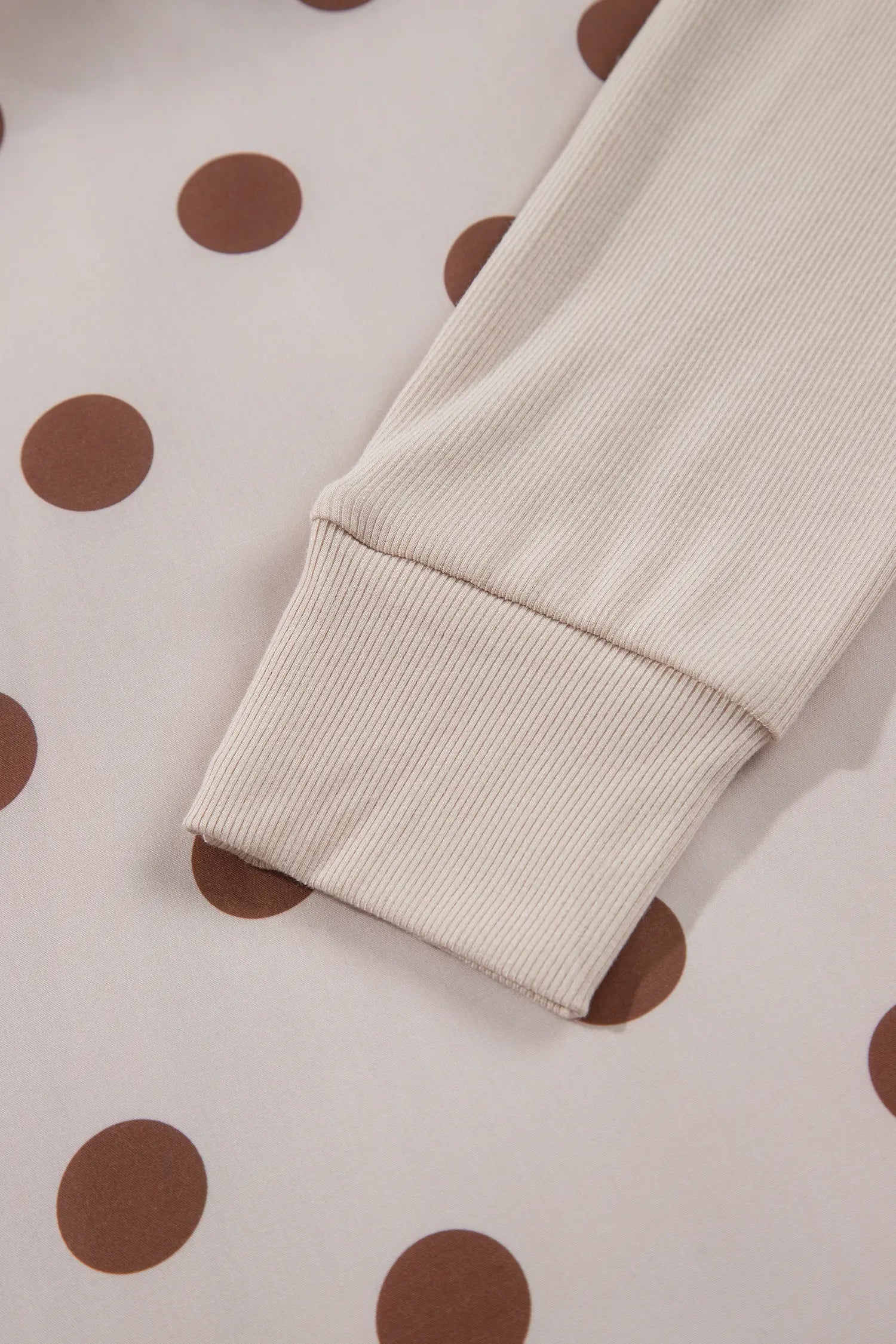 Ribbed cuff on beige long sleeve polka dot dress
