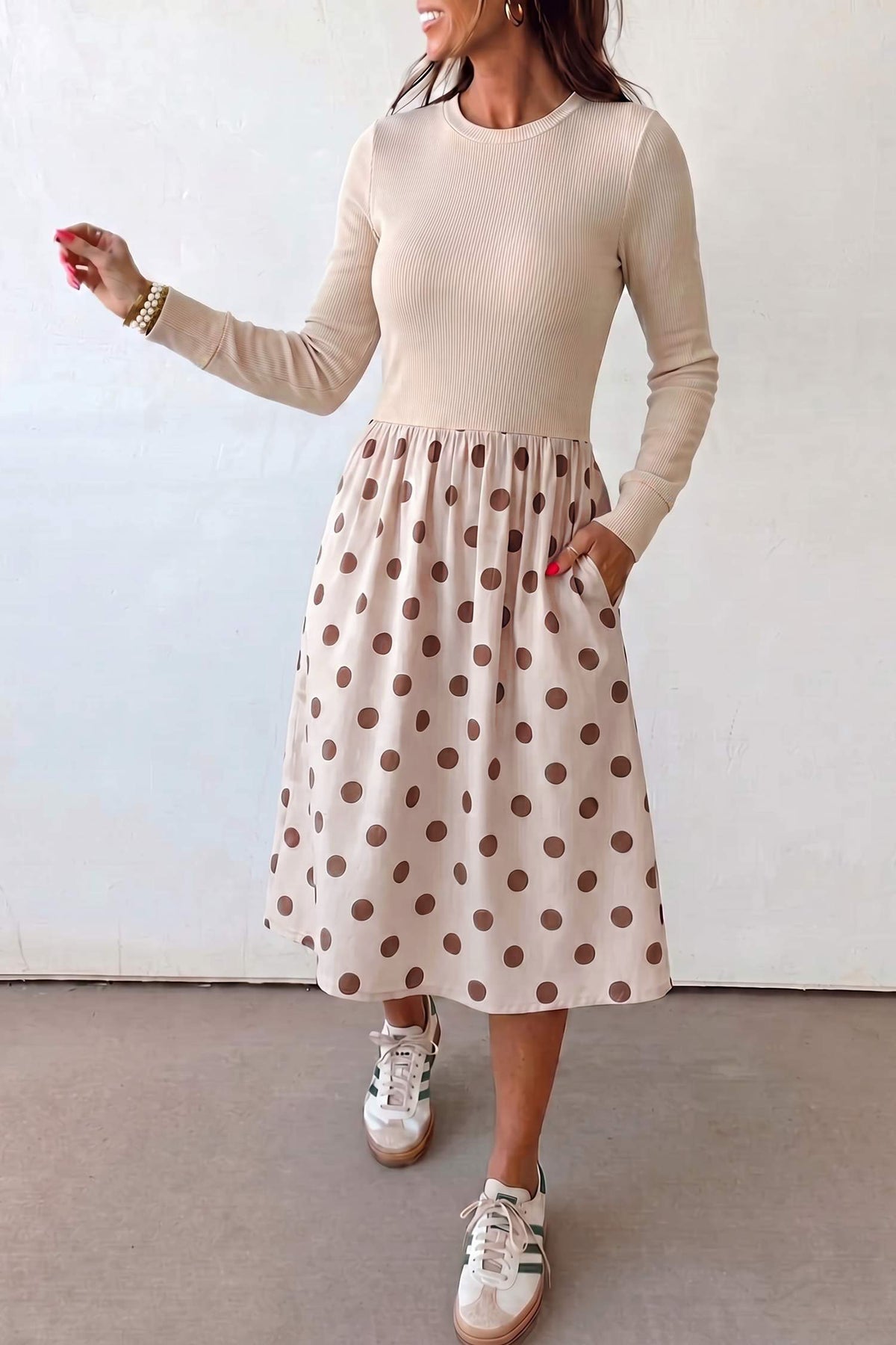 Woman in beige ribbed knit polka dot skirt long sleeve midi dress with white sneakers