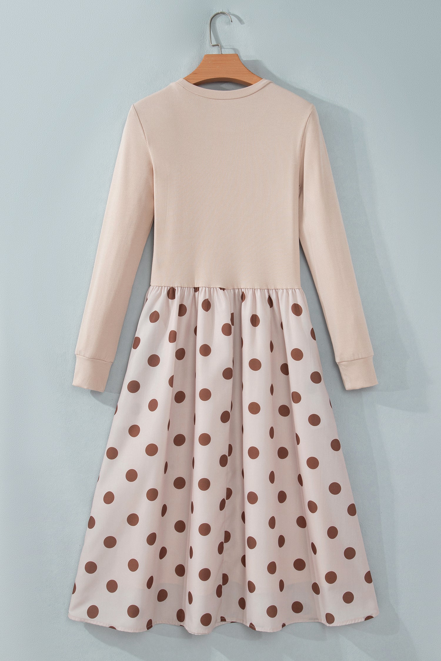 Beige ribbed knit polka dot midi dress on a hanger, back view