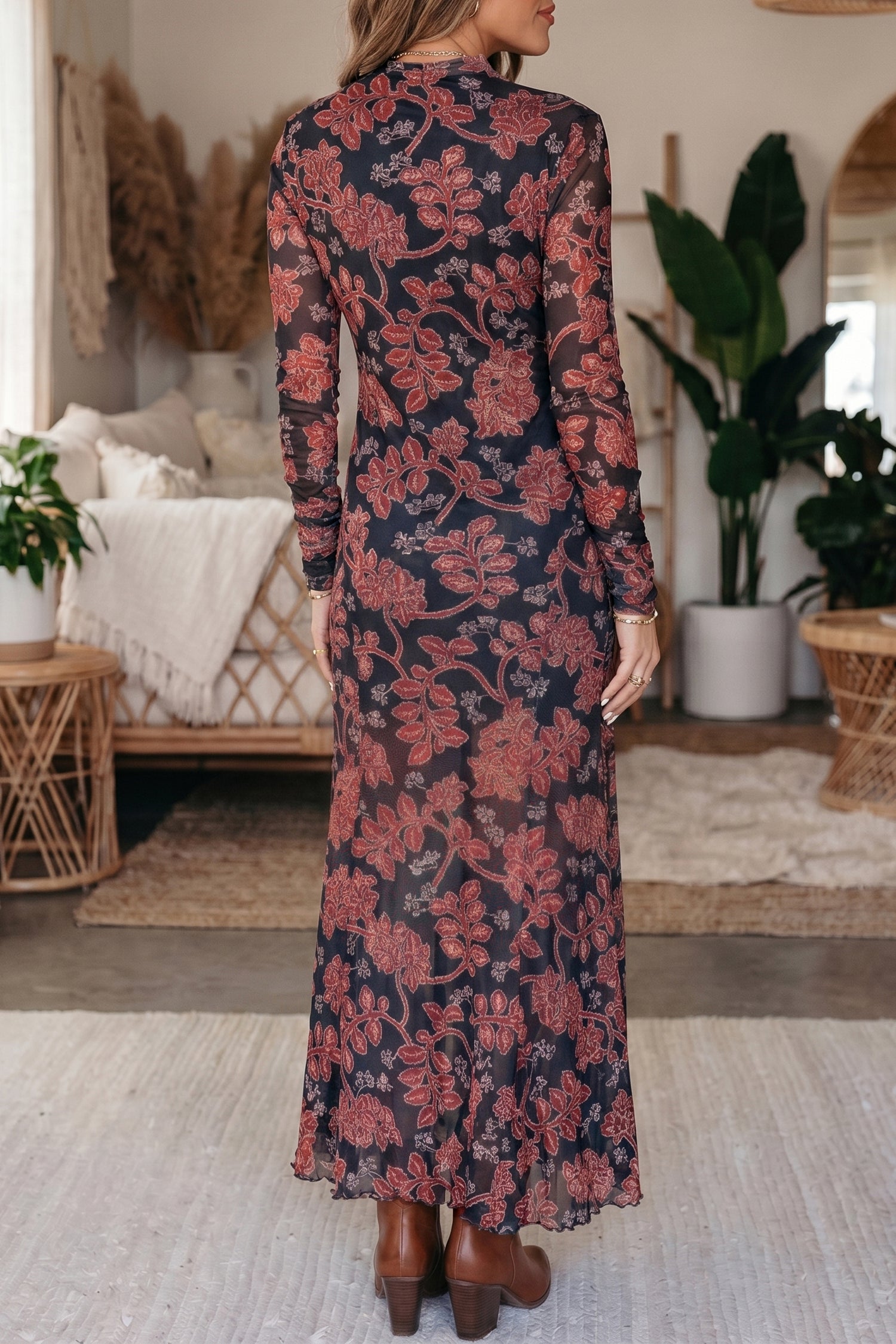 Back view of black and red floral mesh maxi dress with flared hem