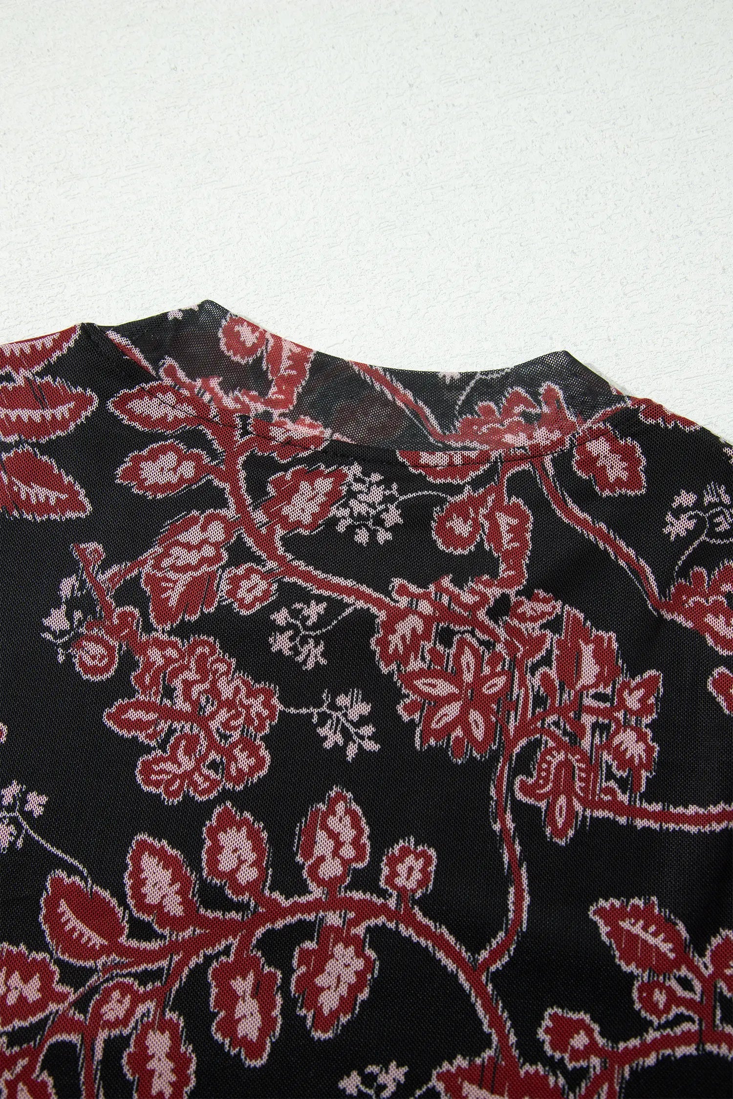Close-up of mock neckline on black retro floral mesh dress
