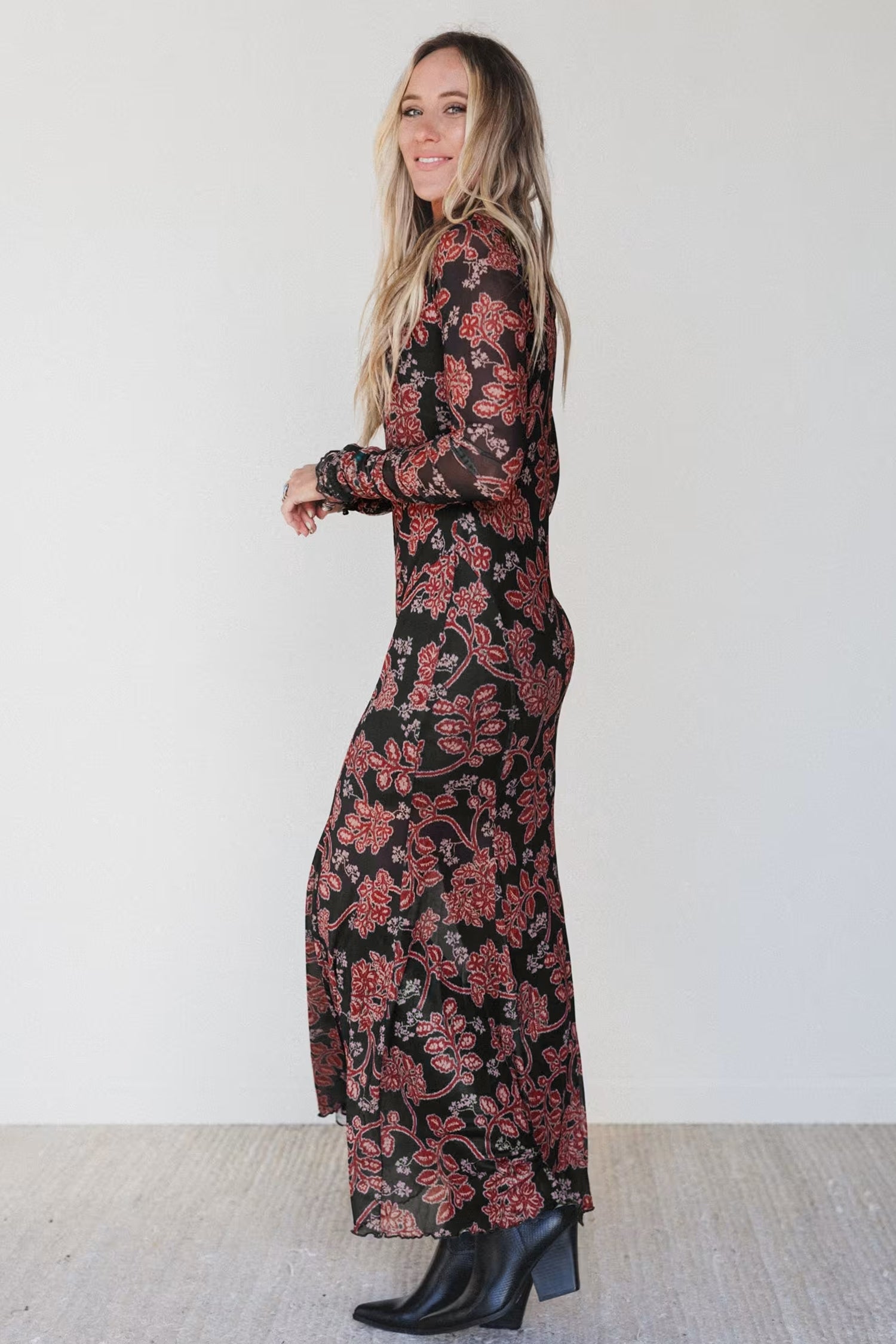 Side view of black retro floral mesh maxi dress with mermaid hem
