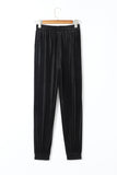 Black velvet elastic waist jogger pants on a hanger, front view