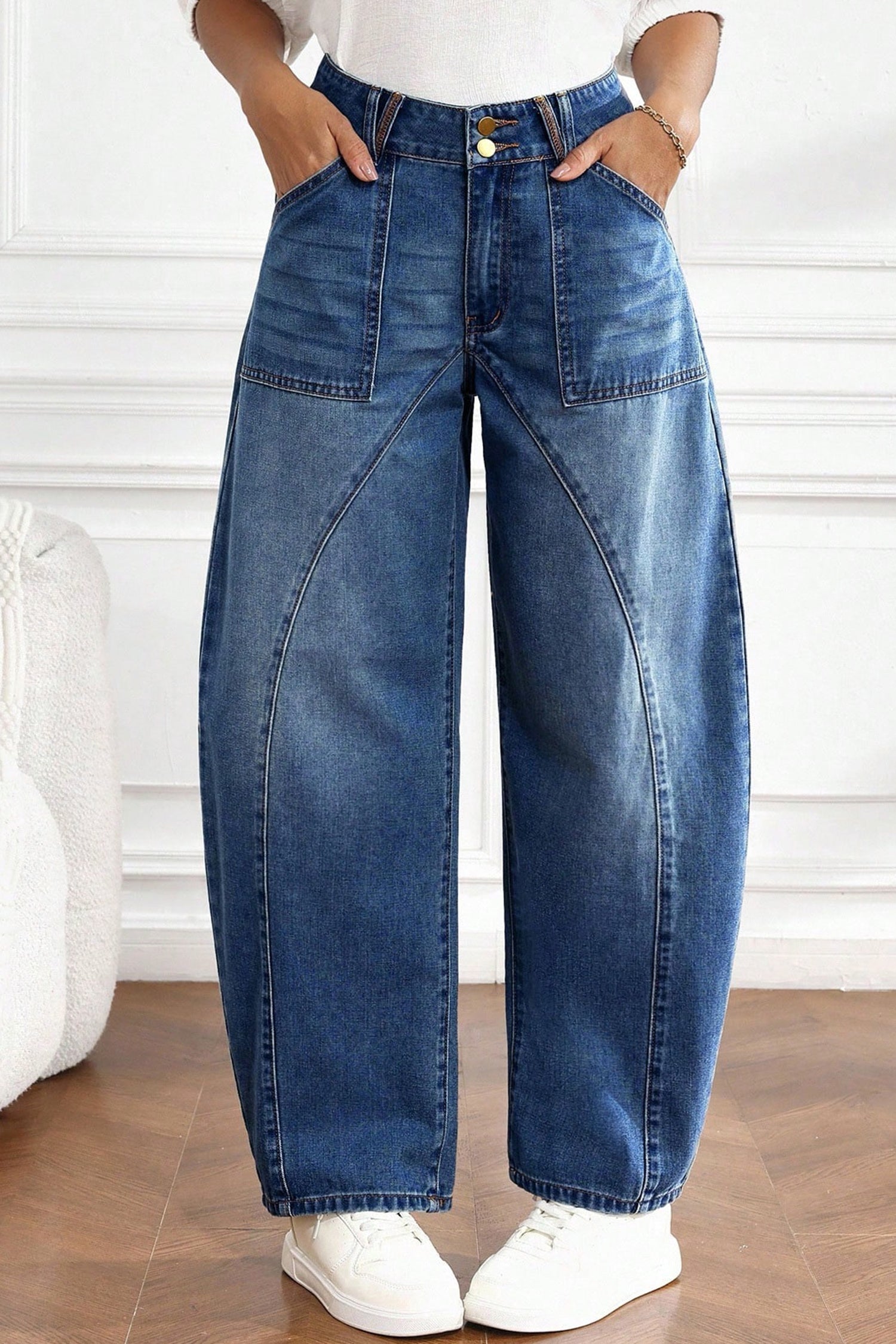 Front of high waist barrel jeans with double button closure and large patch pockets