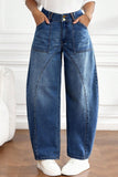 Front of high waist barrel jeans with double button closure and large patch pockets