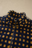 Close-up of stand collar and front zipper on navy check sherpa jacket