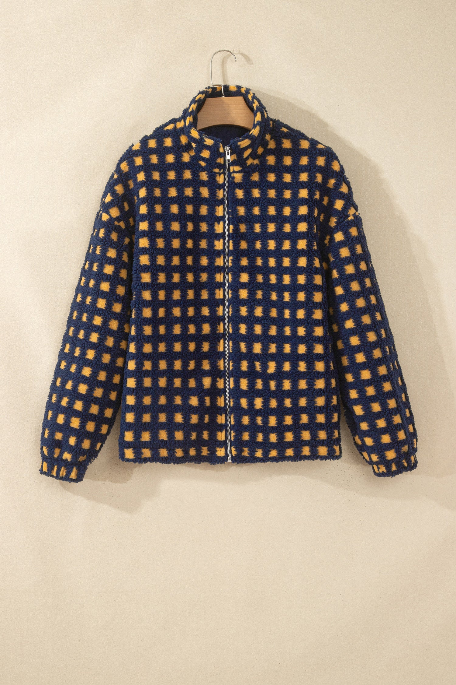 Navy and mustard check sherpa zip up jacket with stand collar on a hanger, front view