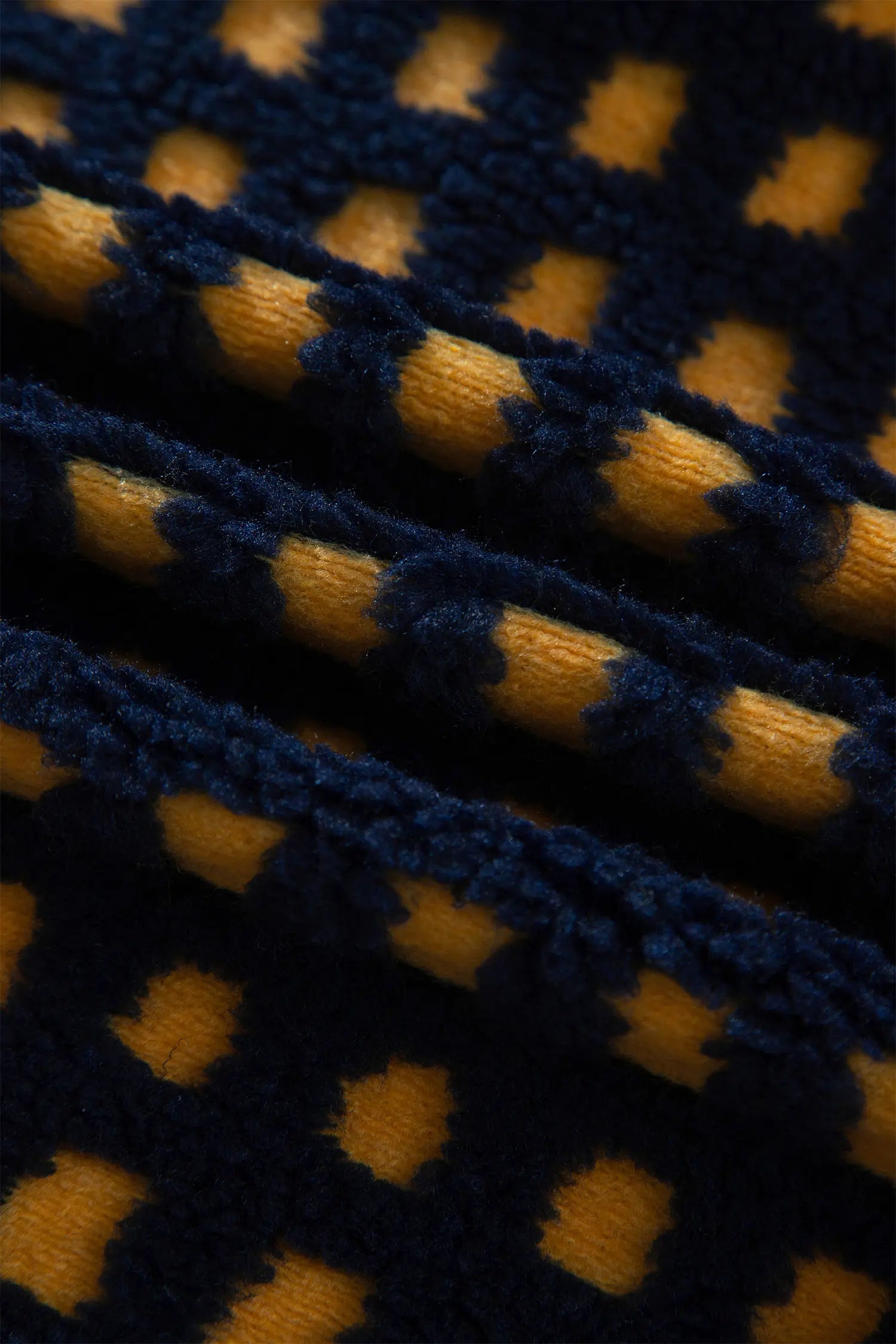 Soft navy and mustard check sherpa fleece fabric close-up